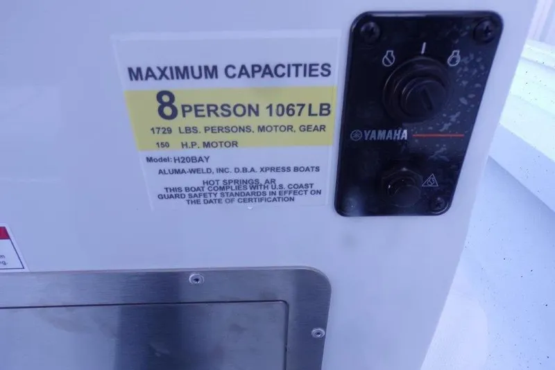 Slide: The Image of 2026 Xpress H20B Bay boat capacity label, Yamaha controls, 8-person, 1729 lbs limit. - 2
