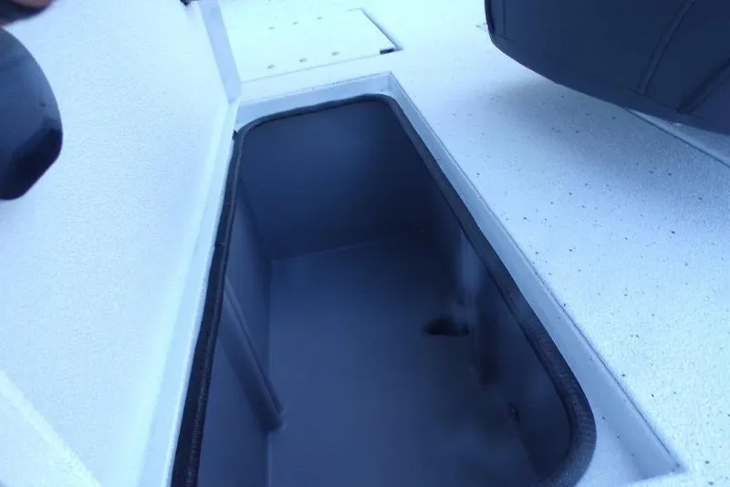 Slide: The Image of Open storage compartment on 2026 Xpress H20B Bay boat deck. - 7