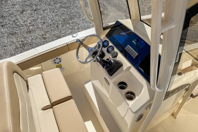 Slide: The Image of 2026 Scout 215 XSF boat interior with steering wheel and control panel. - 22