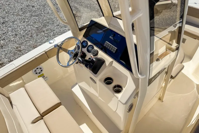 Slide: The Image of 2026 Scout 215 XSF boat interior with steering wheel and control panel. - 23