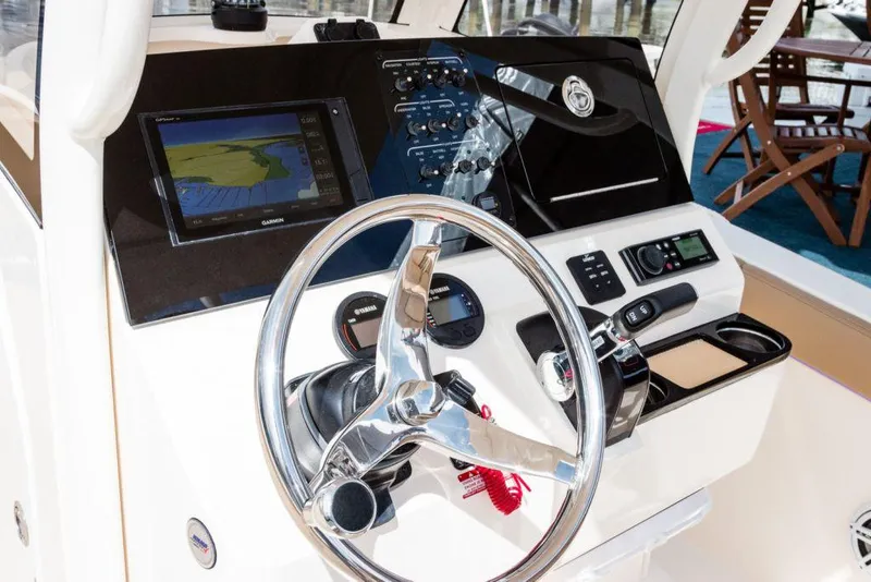 Slide: The Image of 2026 Scout 240 XSF boat interior bathroom with toilet and storage net. - 12