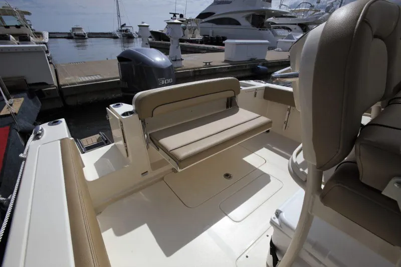 Slide: The Image of 2026 Scout 240 XSF boat interior with white seating and console. - 15