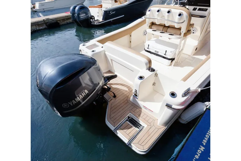 Slide: The Image of Interior of 2026 Scout 240 XSF boat with beige seating and speakers. - 16