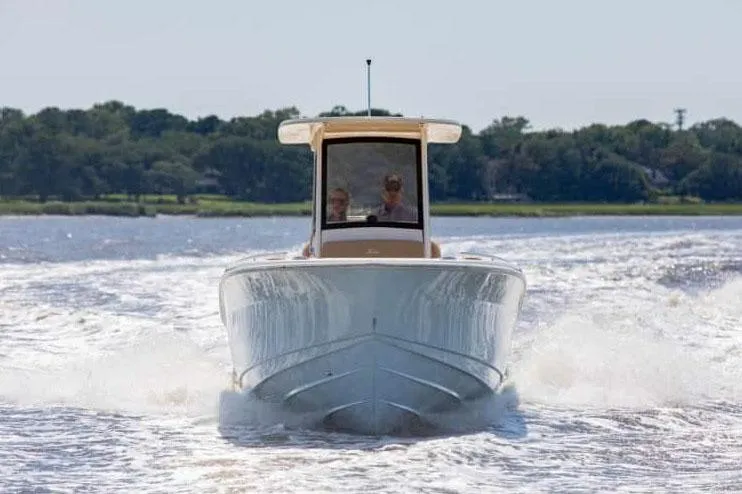 Slide: The Image of 2026 Scout 240 XSF boat in showroom, featuring sleek design and modern amenities. - 2