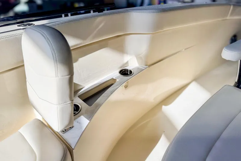 Slide: The Image of Interior of 2026 Scout 240 XSF boat with beige seating and cup holders. - 21