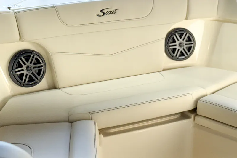 Slide: The Image of 2026 Scout 240 XSF boat interior with beige seating and built-in speakers. - 24