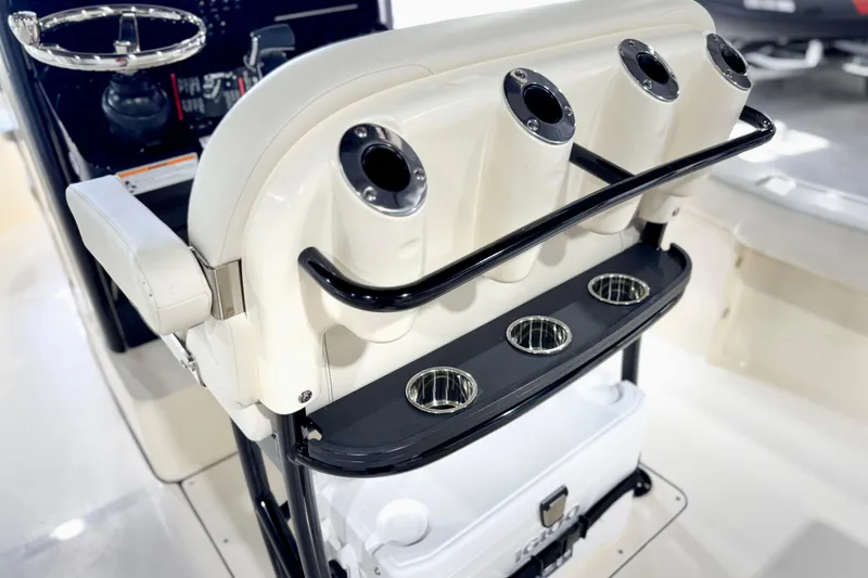 Slide: The Image of 2026 Scout 240 XSF boat interior with rod holders and steering wheel. - 32