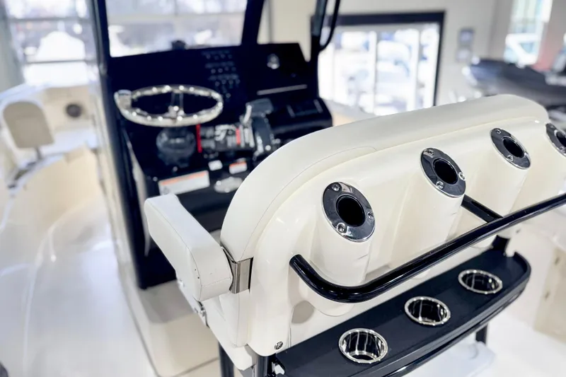 Slide: The Image of 2026 Scout 240 XSF boat interior with steering wheel and rod holders. - 33