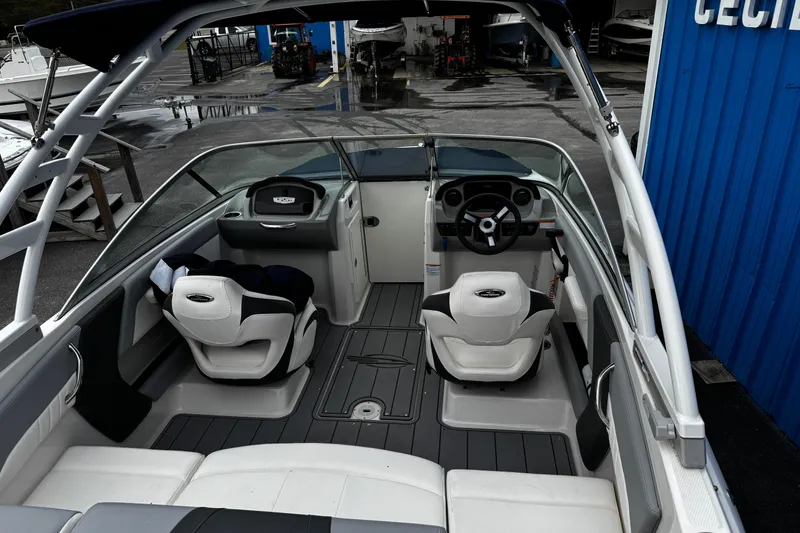 Slide: The Image of 2023 Chaparral 21 SSi OB boat interior with seating and steering wheel. - 11