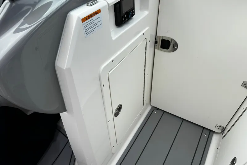 Slide: The Image of 2023 Chaparral 21 SSi OB boat interior, featuring storage compartment and sleek design. - 13