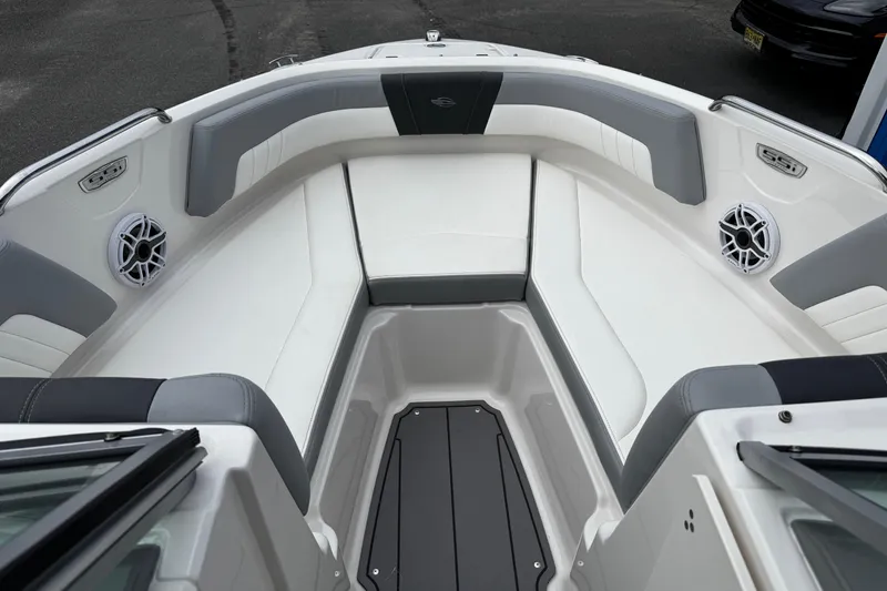 Slide: The Image of 2023 Chaparral 21 SSi OB boat interior with cushioned seating and speakers. - 14