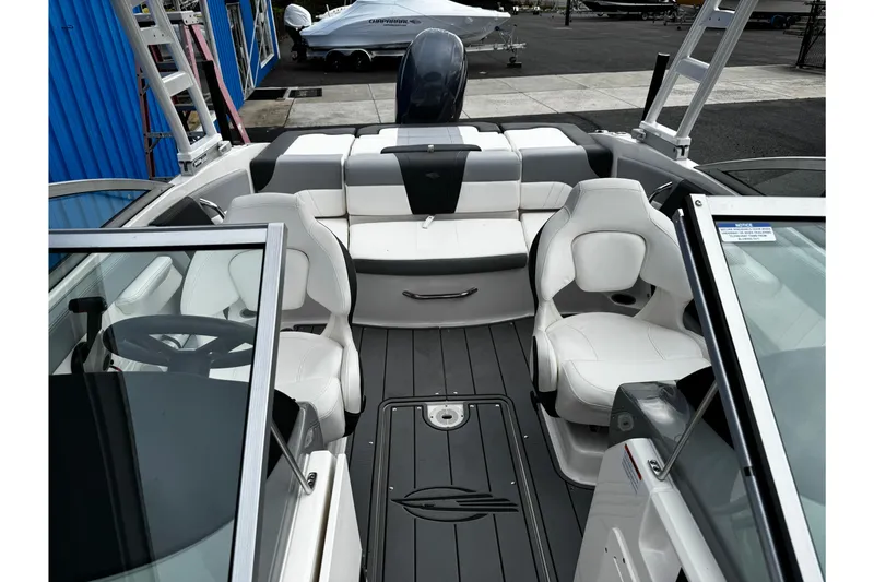 Slide: The Image of 2023 Chaparral 21 SSi OB boat interior with white seating and sleek design. - 16