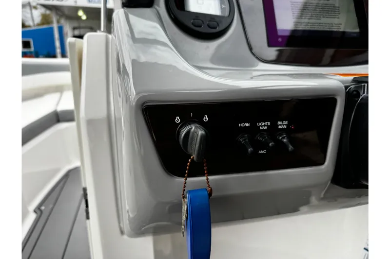 Slide: The Image of Control panel of 2023 Chaparral 21 SSi OB boat with ignition and switches. - 21