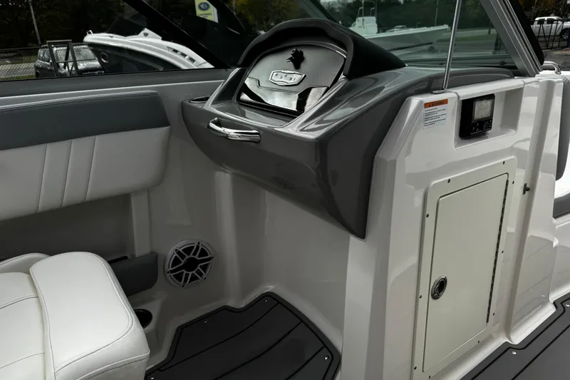 Slide: The Image of 2023 Chaparral 21 SSi OB boat interior with dashboard and seating. - 23
