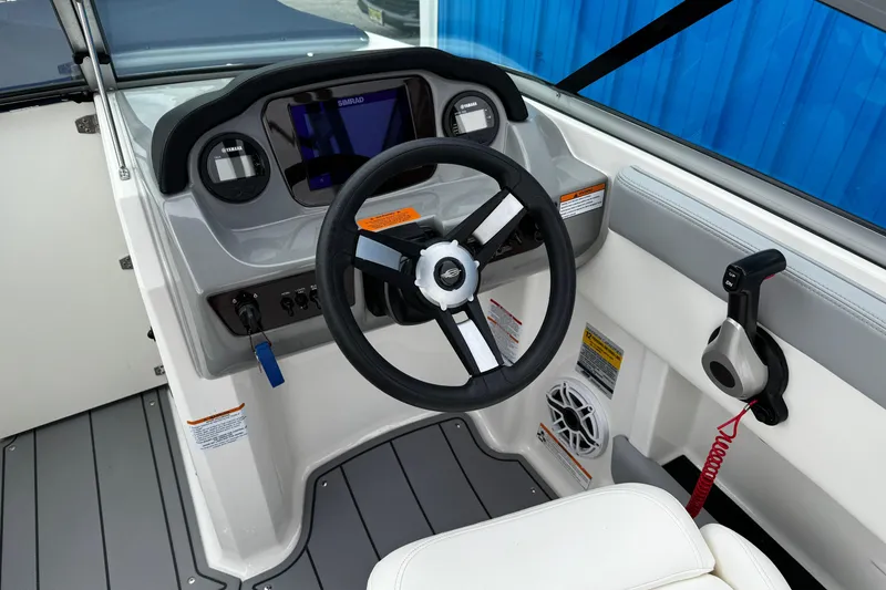 Slide: The Image of 2023 Chaparral 21 SSi OB boat dashboard with steering wheel and controls. - 6