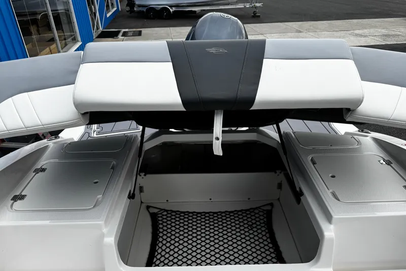 Slide: The Image of 2023 Chaparral 21 SSi OB boat storage compartment with open hatch and netting. - 9