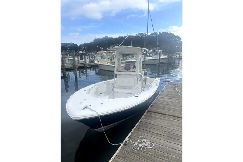 The Image of 2021 Sportsman Heritage 211 Center Console boat docked at marina. - 0