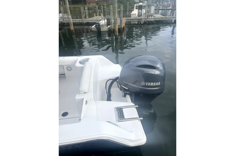 Slide: The Image of 2021 Sportsman Heritage 211 Center Console with Yamaha outboard motor at dock. - 4