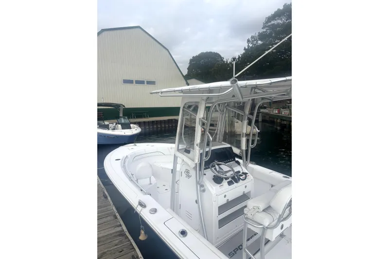 Slide: The Image of 2021 Sportsman Heritage 211 Center Console boat docked near a boathouse. - 5
