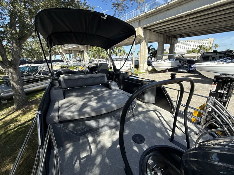 Slide: The Image of Sanpan 2500 MTF 2026 pontoon boat with spacious seating under a bridge. - 15