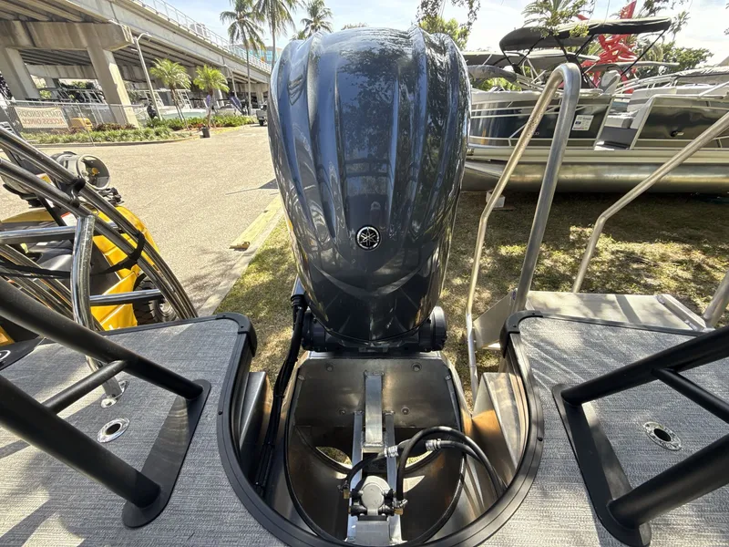 Slide: The Image of Sanpan 2500 MTF 2026 boat engine, docked with surrounding palm trees and boats. - 18