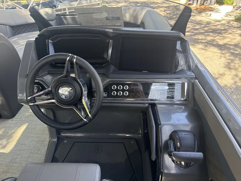 Slide: The Image of Steering console of 2026 Sanpan 2500 MTF boat with modern controls and displays. - 21