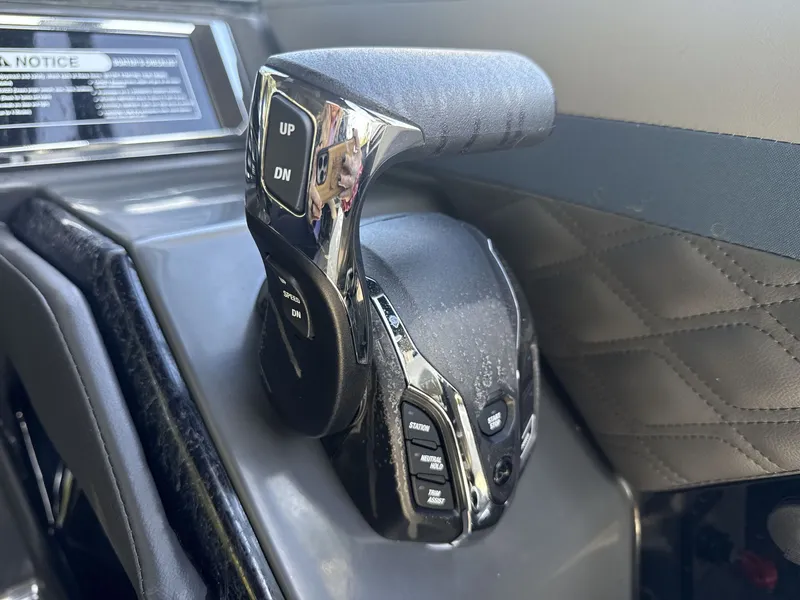 Slide: The Image of Throttle control lever of a 2026 Sanpan 2500 MTF boat, featuring various control buttons. - 22