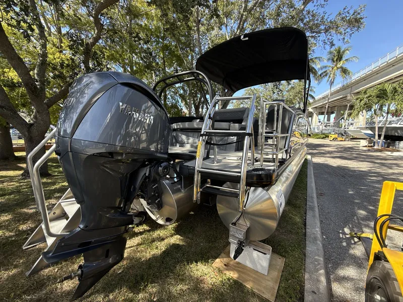 Slide: The Image of Sanpan 2500 MTF pontoon boat, 2026 model, with Yamaha outboard motor, parked under trees. - 4