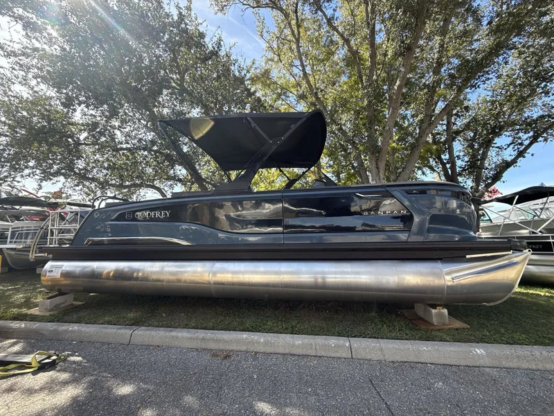 Slide: The Image of 2026 Sanpan 2500 MTF pontoon boat displayed outdoors under trees. - 5