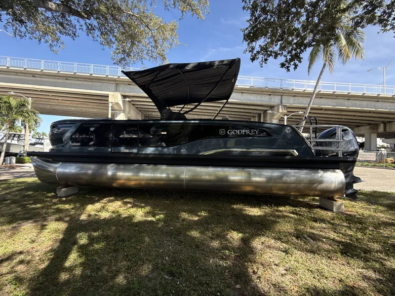 Slide: The Image of Sanpan 2500 MTF pontoon boat, 2026 model, displayed outdoors under a bridge. - 9