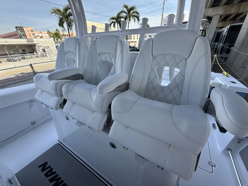 Slide: The Image of Luxurious seating on 2026 Sportsman Open 352 Center Console boat, featuring plush white upholstery. - 11