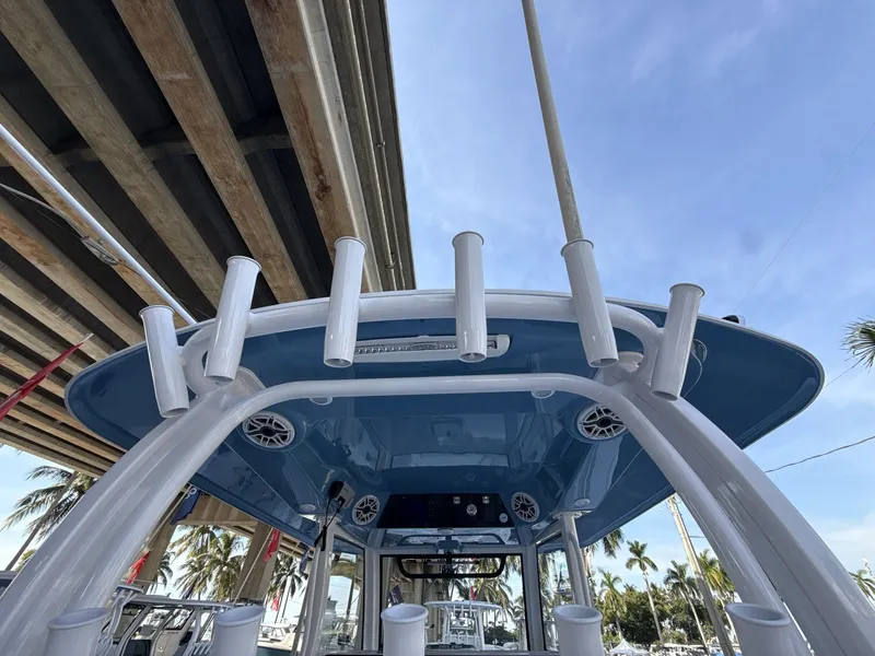 Slide: The Image of 2026 Sportsman Open 352 Center Console boat with rod holders and speakers, viewed from below. - 12