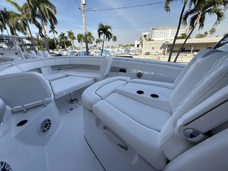 Slide: The Image of 2026 Sportsman Open 352 Center Console boat interior with white seating and cup holders. - 15