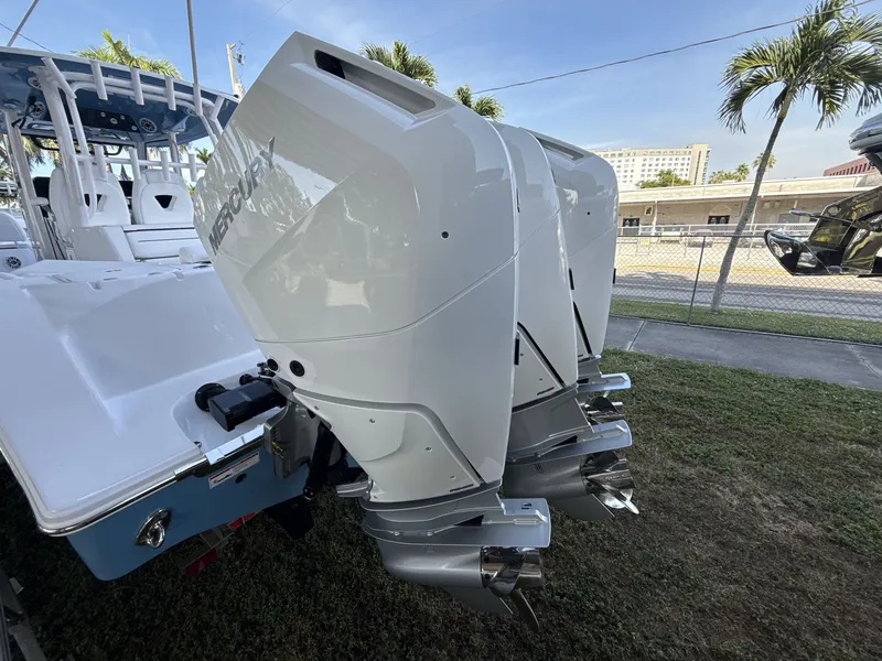 Slide: The Image of 2026 Sportsman Open 352 Center Console with triple Mercury outboard engines, parked outdoors. - 17