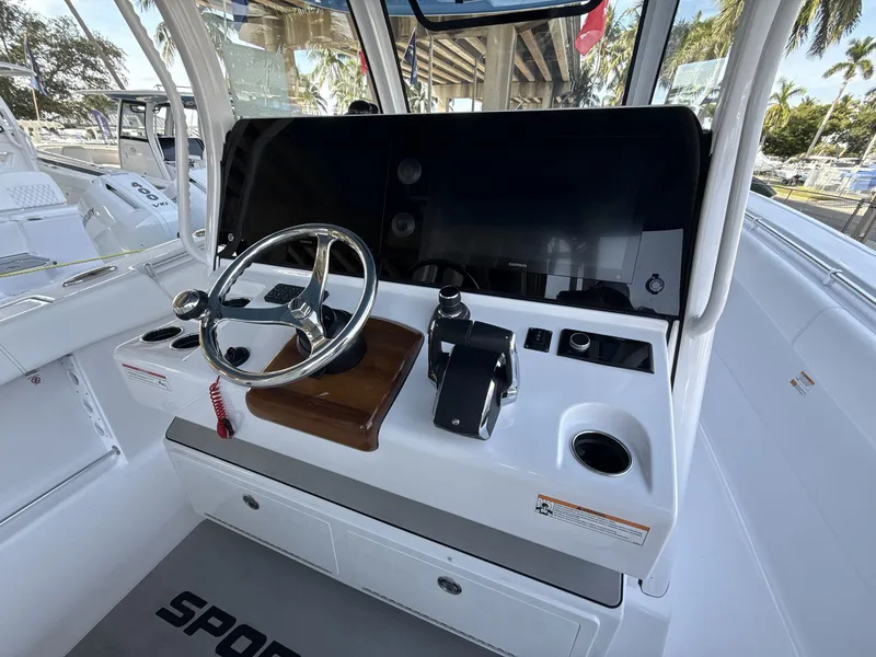 Slide: The Image of 2026 Sportsman Open 352 Center Console helm with steering wheel and navigation display. - 21
