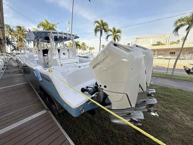 Slide: The Image of 2026 Sportsman Open 352 Center Console boat with triple Mercury engines docked. - 3