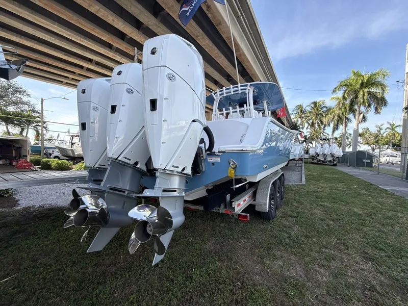 Slide: The Image of 2026 Sportsman Open 352 Center Console boat with triple outboard engines on a trailer. - 5