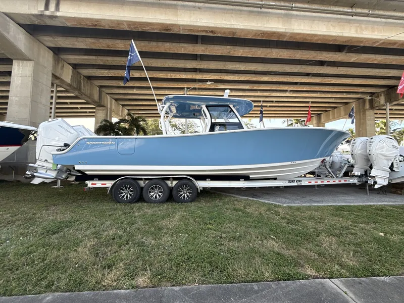Slide: The Image of 2026 Sportsman Open 352 Center Console boat on trailer under bridge. - 6