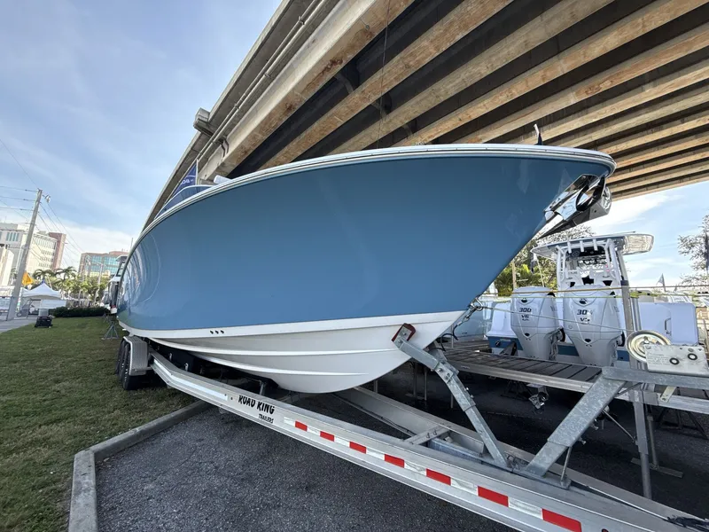 Slide: The Image of 2026 Sportsman Open 352 Center Console boat on trailer under bridge. - 7