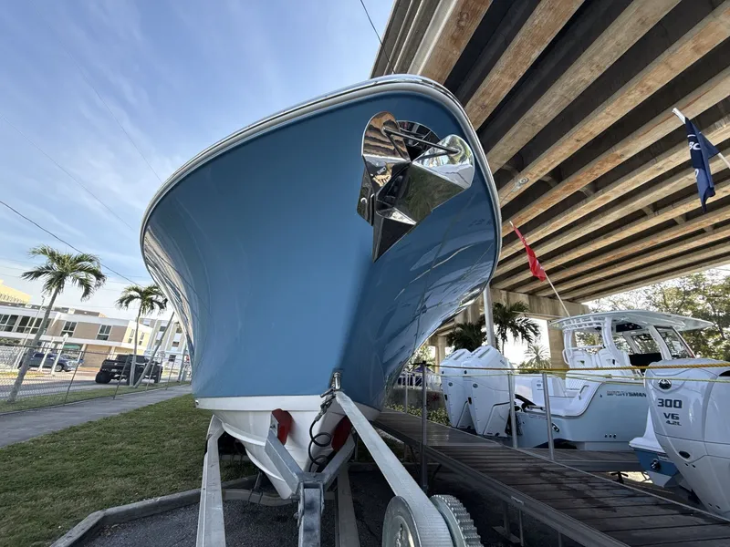 Slide: The Image of 2026 Sportsman Open 352 Center Console boat displayed under a bridge. - 8