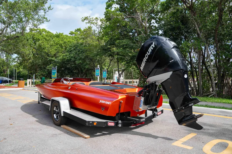 Slide: The Image of 1984 Sleekcraft Aristocrat 20 boat with Mercury engine on trailer, parked outdoors. - 11