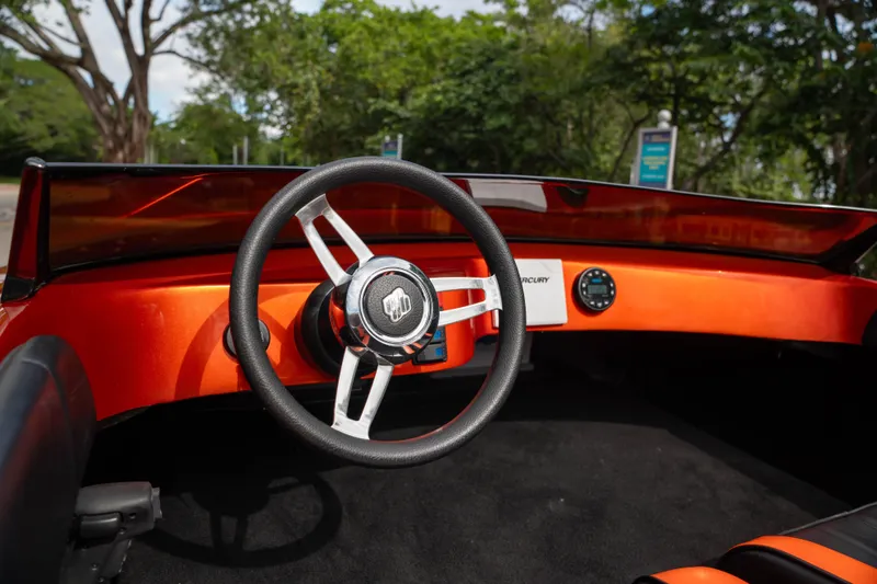 Slide: The Image of 1984 Sleekcraft Aristocrat 20 boat interior with orange dashboard and steering wheel. - 12
