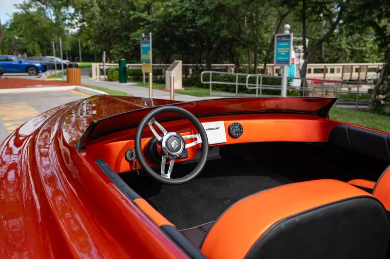 Slide: The Image of 1984 Sleekcraft Aristocrat 20 boat interior with orange accents and steering wheel. - 18