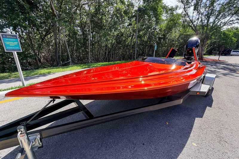 Slide: The Image of Red 1984 Sleekcraft Aristocrat 20 boat on trailer, parked near trees. - 22