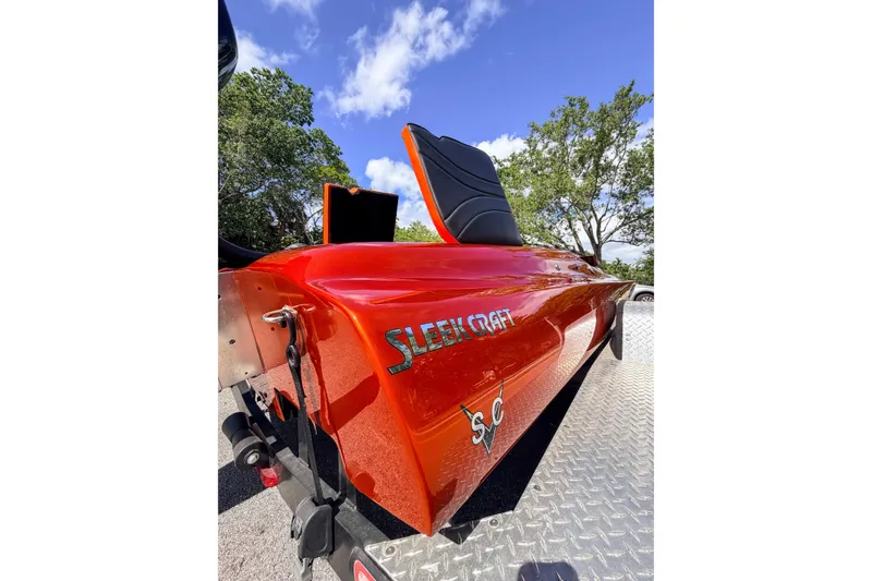Slide: The Image of 1984 Sleekcraft Aristocrat 20 boat with vibrant red finish on a trailer. - 24