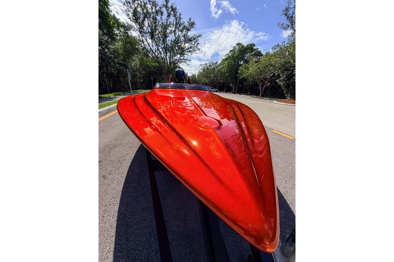 Slide: The Image of 1984 Sleekcraft Aristocrat 20 boat with vibrant red finish on a sunny road. - 25