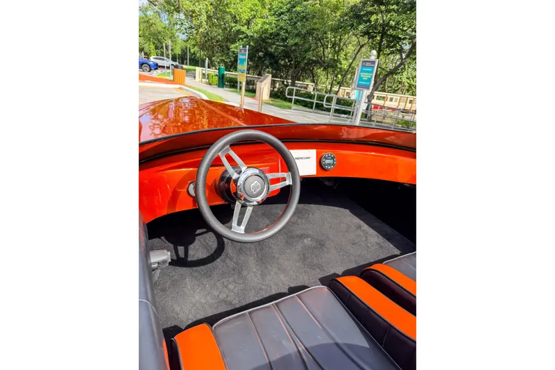 Slide: The Image of 1984 Sleekcraft Aristocrat 20 boat interior with red dashboard and steering wheel. - 28