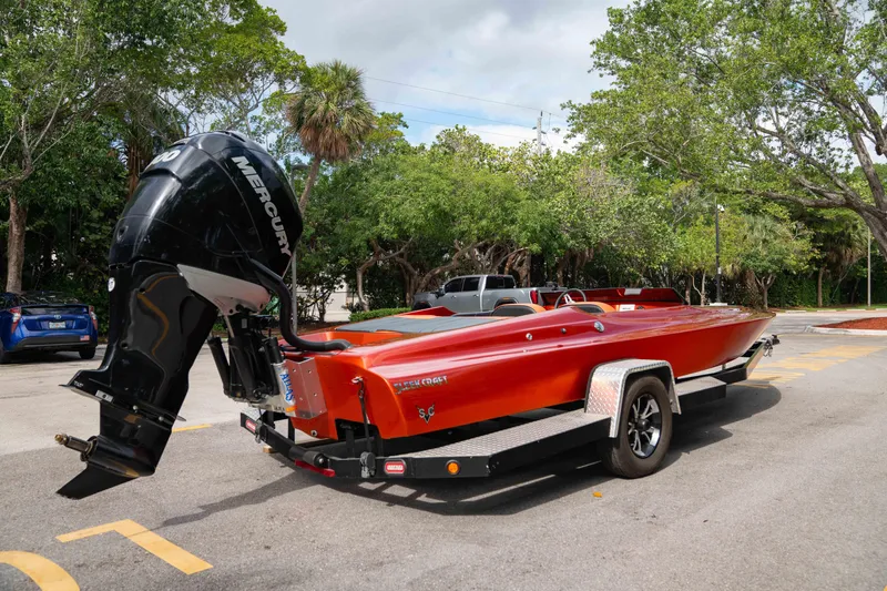 Slide: The Image of 1984 Sleekcraft Aristocrat 20 boat on trailer with Mercury outboard motor in parking lot. - 9