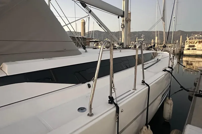 Slide: The Image of 2022 Bavaria C45 yacht docked in a marina, surrounded by other boats. - 13