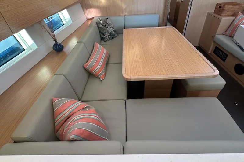 Slide: The Image of Interior of 2022 Bavaria C45 yacht with cozy dining area and striped cushions. - 25